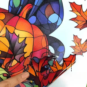 Close-up of double-sided autumn pumpkin window sticker showing its translucent texture