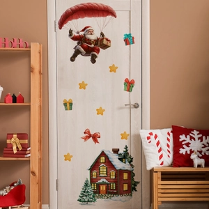 Detailed view of festive Santa Claus wall stickers on a white door with holiday decor