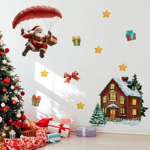 Close-up of watercolor Christmas wall stickers with Santa and cozy winter cabin decor