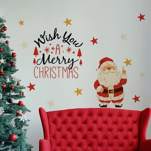Detail of Santa Claus and Merry Christmas wall decals on a gray wall behind a red velvet sofa