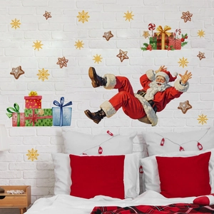 Detail of Christmas Santa wall stickers with gift boxes and golden snowflakes on white wall