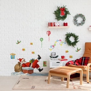 Detail of Christmas wall stickers showing Santa on a chimney and festive decorations