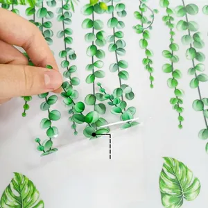 Detail showing double-sided colorful plant leaf window stickers with vivid patterns