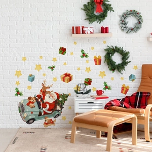 Detail of Christmas wall stickers showing Santa in a vintage car with reindeer and stars