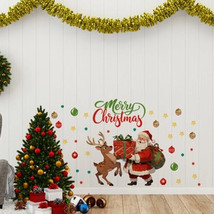 Detail showing Santa Claus and Merry Christmas wall stickers on a white wooden wall