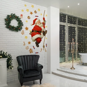 Detail of Christmas wall decals with Santa climbing and festive gingerbread elements
