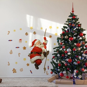Detail of Christmas wall decals showing a climbing Santa with stars and gingerbread man