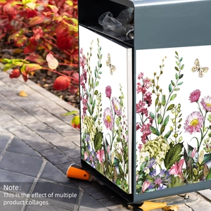 Macro detail of colorful floral and butterfly decals applied to a metal outdoor trash bin