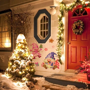 Outdoor Christmas gnomes wall decals applied on house wall next to festive front door