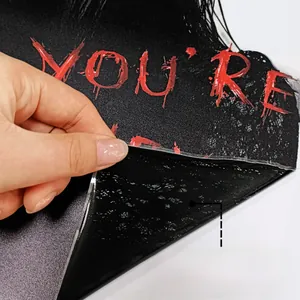 Macro detail of Halloween window sticker showing dual-sided color patterns and protective film
