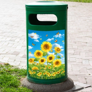 Detailed outdoor view of a green trash can featuring a vibrant sunflower and butterfly decal
