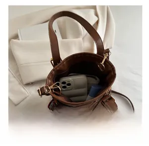 Top view of leopard print bucket bag interior showing phone, wallet and accessories