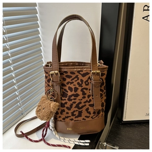 Detail of leopard print bucket bag with plush bear charm and Fashion & Bag text