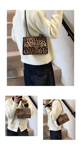 Detail view of leopard print shoulder bag with metal chain strap and studded flap detail