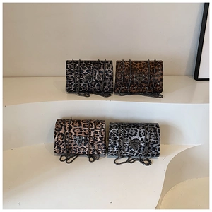 Detail of four leopard print crossbody bags with metal studs and chain straps