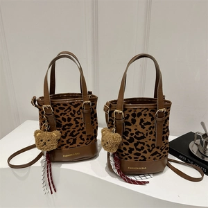 Retro leopard print bucket bag with brown leather trim and cute plush bear charm