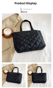 Detail of black quilted nylon tote bag with diamond pattern and fashion brand patch