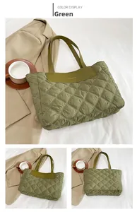Detail of green quilted nylon tote bag featuring a leather fashion patch and shoulder straps