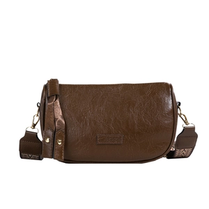 Retro brown faux leather crescent crossbody bag with ethnic style woven shoulder strap