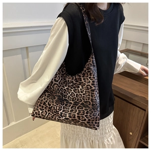 Detailed view of oversized leopard print tote bag styled with a minimalist outfit