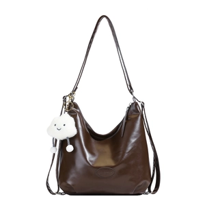 Dark brown high-gloss leather hobo bag with long straps and white cloud plush charm