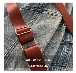 Detailed close-up of dark red woven strap with high-quality golden metal adjustment buckle