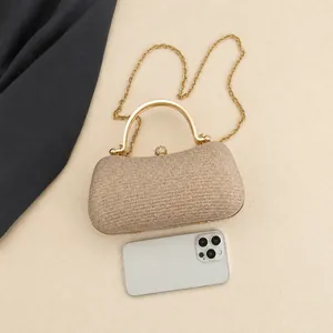 Golden sequin evening bag with chain strap and phone size comparison on white fabric