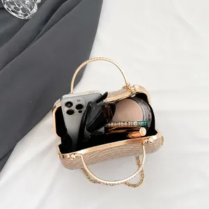 Internal view of a gold clutch bag showing capacity for phone and cosmetics
