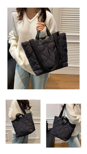 Detailed view of the quilted diamond pattern on a black oversized puffer tote bag