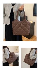 Detail of brown quilted nylon tote bag featuring a metal logo and deer charm accessory