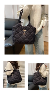 Detail of black quilted tote bag with diamond stitching and elegant deer pendant charm