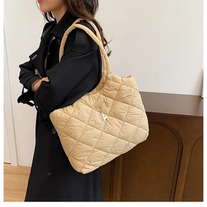 Quilted beige puffer tote bag with deer charm and spacious interior for women