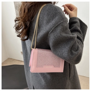 Détail d'un sac rose avec panneau en strass étincelants et bandoulière chaîne dorée