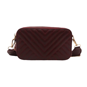 Quilted burgundy crossbody bag with chevron stitching and wide canvas shoulder strap