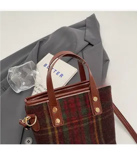 Detailed view of vintage plaid wool tote with brown leather handles and gold rivet accents
