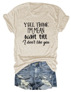 Detail of oatmeal t-shirt with black slogan paired with distressed denim shorts