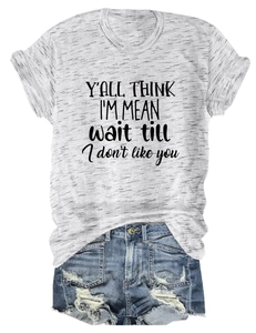 Macro detail of slogan print and distressed denim hem on casual short sleeve gray t-shirt