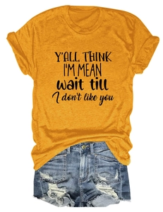 Detail of yellow round neck t-shirt with slogan and distressed denim shorts set