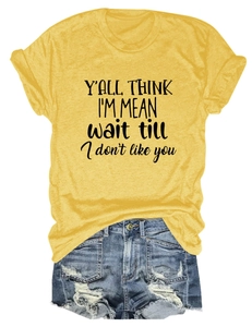 Close-up of yellow round neck T-shirt with black slogan and cuffed short sleeves