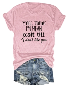 Detail of pink cotton T-shirt featuring black slogan print with distressed denim shorts