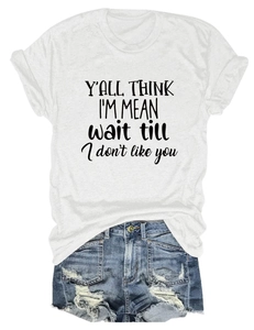 Flat lay of white T-shirt with 'Y'all Think I'm Mean' print and distressed denim shorts