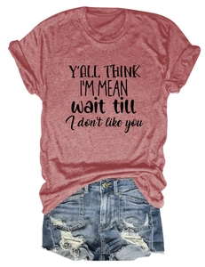 Flat lay of a red graphic t-shirt with text and distressed denim shorts on white background