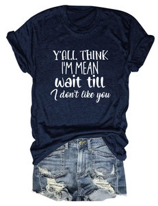 Detail showing the white printed slogan on navy t-shirt with distressed denim shorts