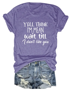 Detail view of purple crew neck T-shirt with white slogan and distressed denim shorts