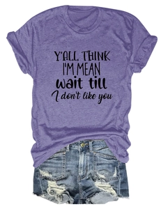Flat lay of purple slogan T-shirt with rolled sleeves and distressed denim shorts
