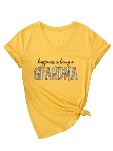 Detail of yellow V-neck t-shirt featuring floral Grandma text and front knot design