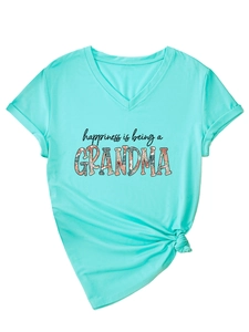 Detail of V-neck mint green T-shirt featuring happiness floral print and knotted hem