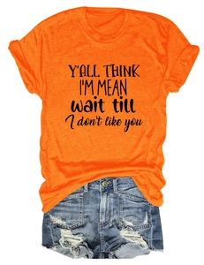 Detail of orange T-shirt with Y'all Think I'm Mean slogan and distressed denim shorts