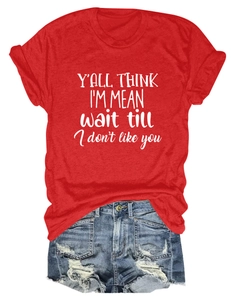 Close-up of red cotton T-shirt with white text and distressed denim shorts detail
