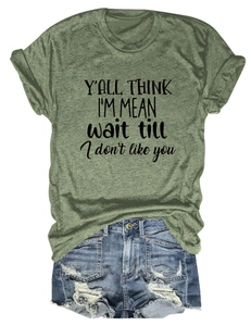 Close-up of green round neck T-shirt with Y'ALL THINK I'M MEAN text print detail